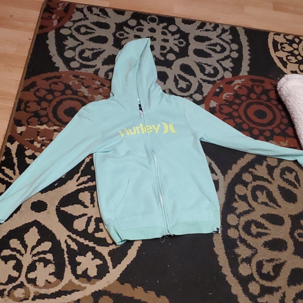 A teal zip up